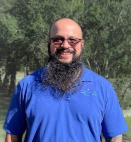 Portrait of Jorge Rivera, Asset & Maintenance Manager, smiling in an outdoor setting.