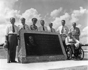 Black and white photo of Congressman Joseph Jefferson Mansfield sitting alongside other individuals at the Mansfield Dam Monument dedication. Photo rights LCRA.